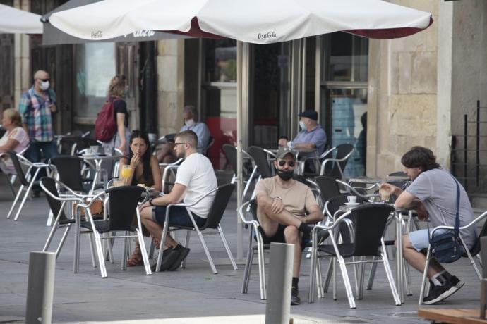 Personas sentadas en la terraza de un bar.