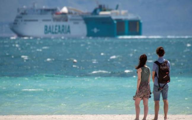 Una pareja pasea por la playa de Alcudia en Palma de Mallorca.