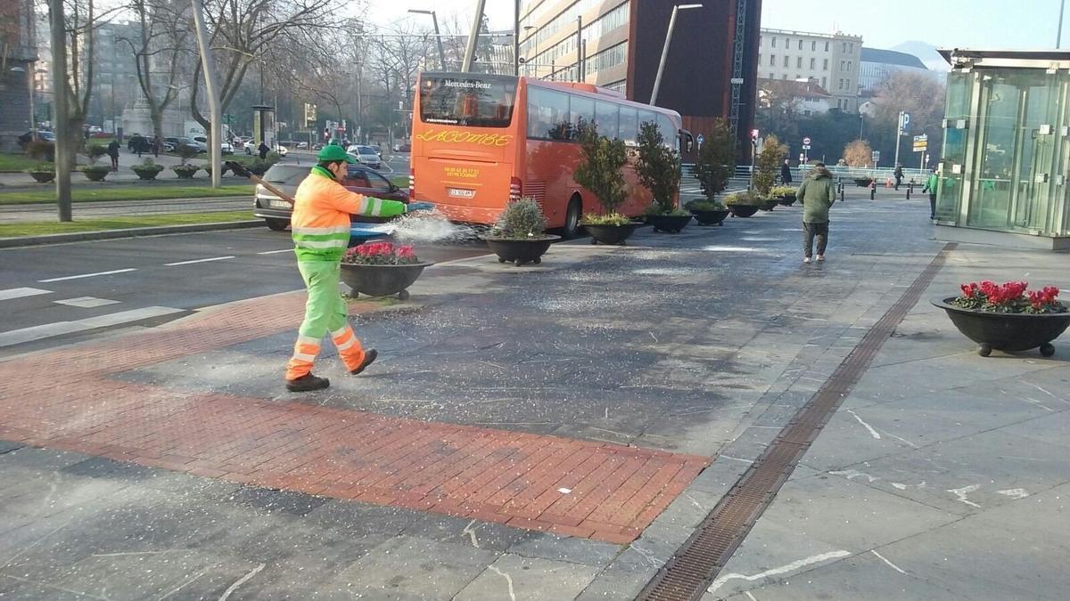 Imagen de un operario esparciendo sal en Bilbao