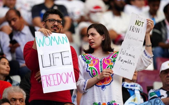 Hinchan iraníes sostienen carteles de protesta en las gradas durante la Copa Mundial de la FIFA Qatar 2022. Hinchan iraníes sostienen carteles de protesta en las gradas durante la Copa Mundial de la FIFA Qatar 2022.