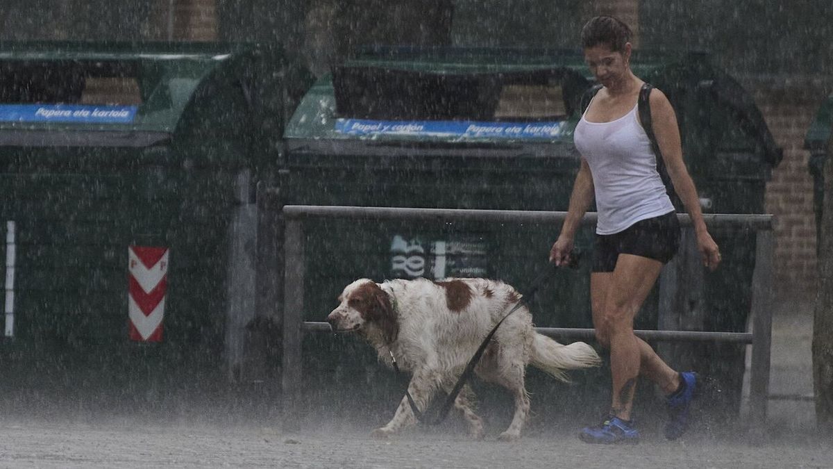 Una joven, sorprendida por la tormenta que cayó la primera semana de agosto mientras paseaba a su perro