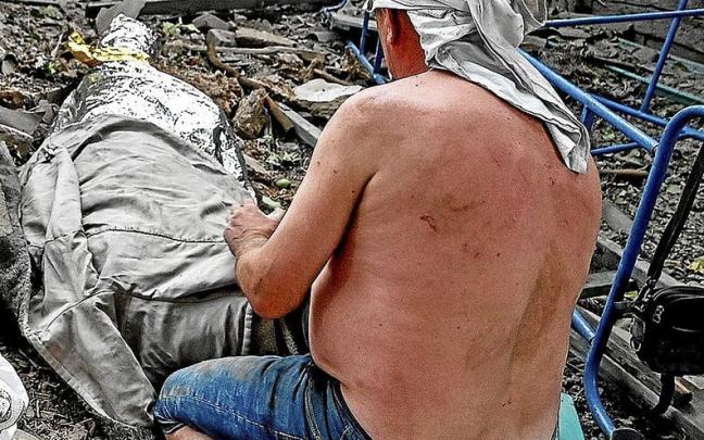 Un hombre llora la muerte de su hijo de once años en el ataque de Dnipropetrovsk. | FOTO: E.P.