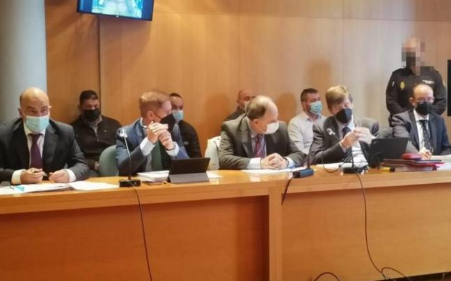 Los condenados por el asesinato, sentados detrás de sus abogados. Los condenados por el asesinato, sentados detrás de sus abogados.