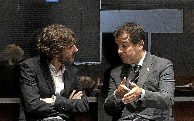 Mikel Buil (Podemos), con el consejero de Desarrollo Económico, Mikel Irujo, en el Parlamento.