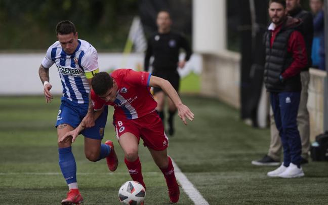 Eneko Martínez (Izarra) pugna con Bujanda (Mutilvera), ante la presencia de los técnicos.