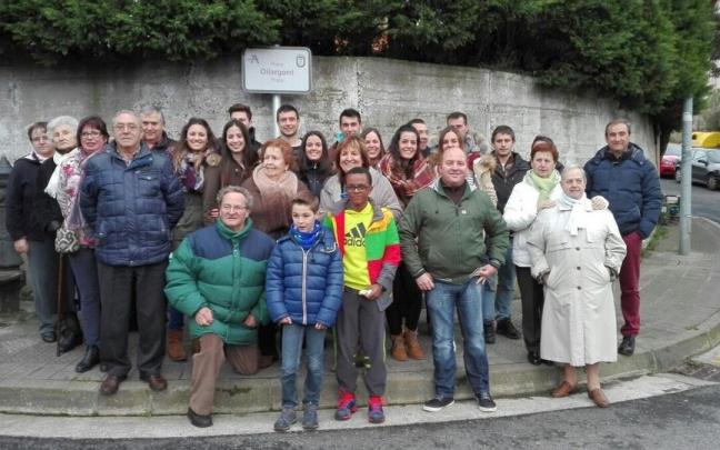 Vecinos y miembros de la asociación cultural posan ante la placa que en 2016 dedicaba la plaza de Kotarro a Oilargorri Elkartea.
