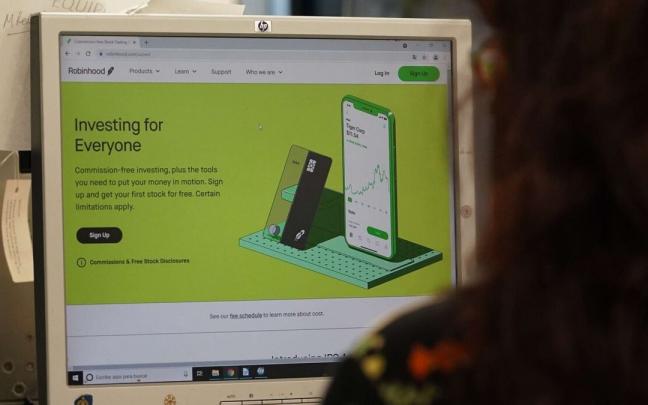 Una mujer observa en su ordenador la pagina de Robinhood. Una mujer observa en su ordenador la pagina de Robinhood.