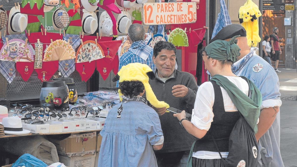 Un niño se prueba un llamativo gorro en un puesto de venta ambulante.