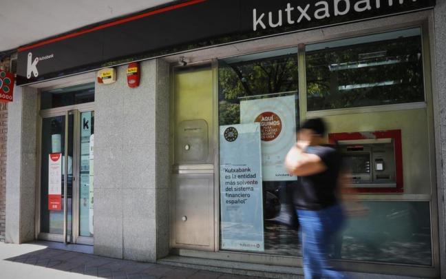 Una persona pasa por delante de una sucursal bancaria. Una persona pasa por delante de una sucursal bancaria.