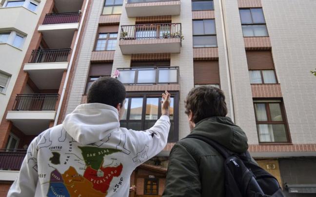 Dos jóvenes contemplan un bloque de viviendas en Bilbao Dos jóvenes contemplan un bloque de viviendas en Bilbao