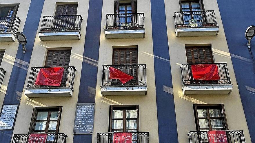 Carteles rojos que están colocando en sus balcones los vecinos movilizados.