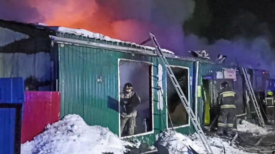 Bomberos en la residencia incendiada.