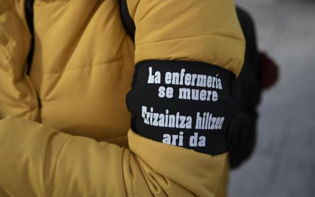 Participante en una concentración convocada por SATSE con un brazalete con el eslógan "La enfermería se muere" Participante en una concentración convocada por SATSE con un brazalete con el eslógan "La enfermería se muere"