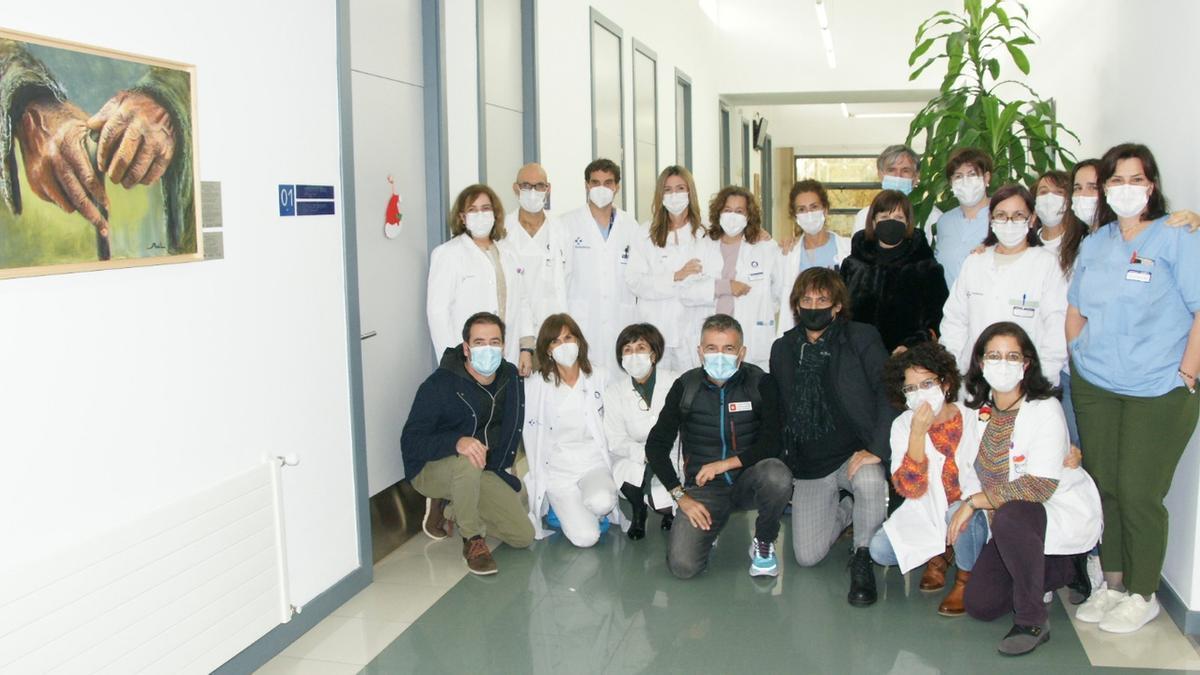 El personal sanitario del ambulatorio de Etxebarri posa junto a los autores de los cuadros.