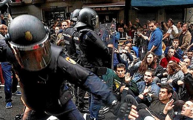 Agentes policiales cargan contra ciudadanos que defendían la jornada del referéndum. | FOTO: EFE Agentes policiales cargan contra ciudadanos que defendían la jornada del referéndum. | FOTO: EFE