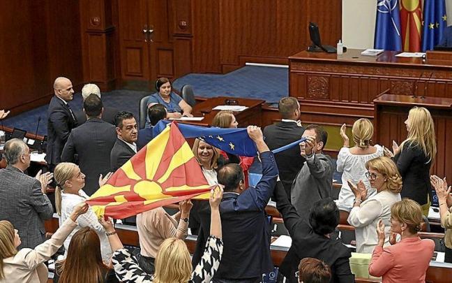 Diputados de la coalición gobernante exhiben banderas de Macedonia del Norte y de la UE tras la aprobación del Parlamento. | FOTO: EFE Diputados de la coalición gobernante exhiben banderas de Macedonia del Norte y de la UE tras la aprobación del Parlamento. | FOTO: EFE