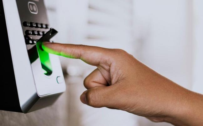 Una persona maneja con su huella una alarma.