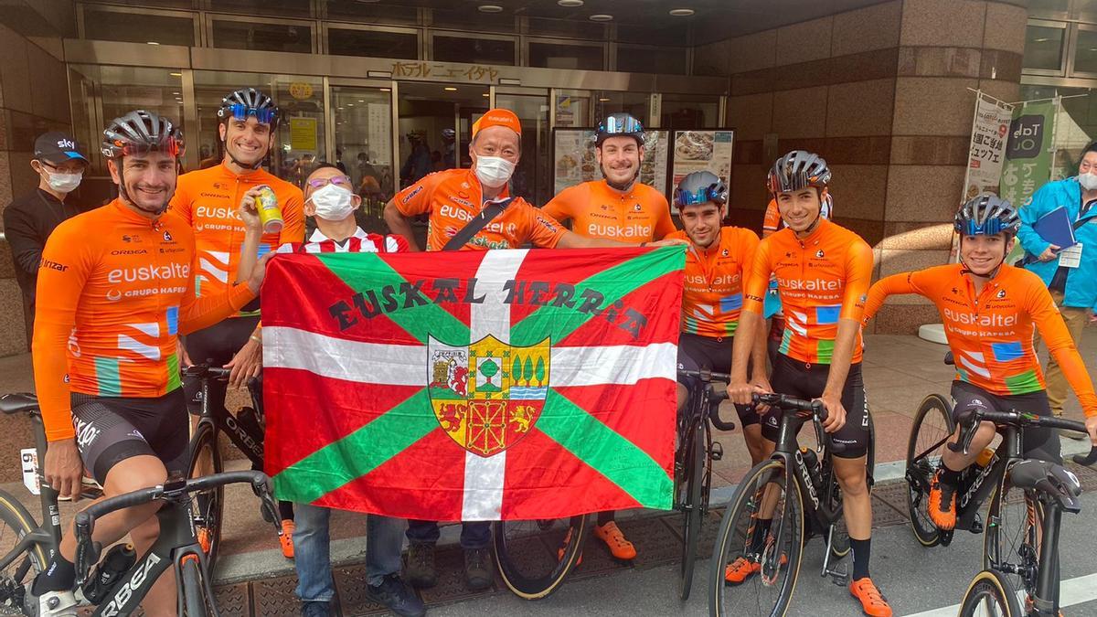 Aficionados japoneses posan con los ciclistas del Euskaltel-Euskadi.