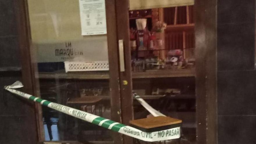 Puerta con el cristal roto en el local al que accedieron dos encapuchados la semana pasada.