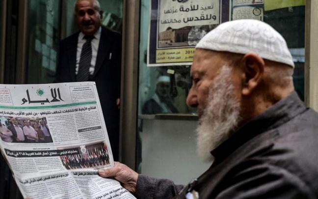 Un hombre lee en un peri&oacute;dico la noticia de la victoria de Netanyahu en las elecciones.