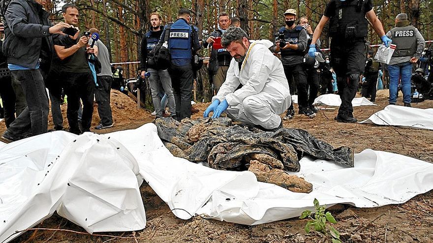 Un forense examina uno de los cuerpos hallados en una fosa común en la localidad de Izium.