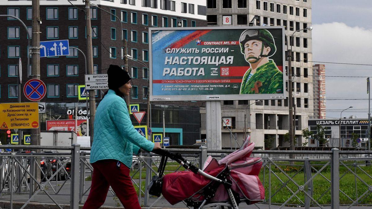 Una mujer pasea en Moscú ante un cartel que promociona el servicio militar por contrato.