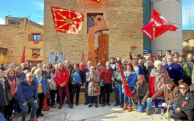 Los asistentes posan con banderas navarras frente a la estatua del mariscal.