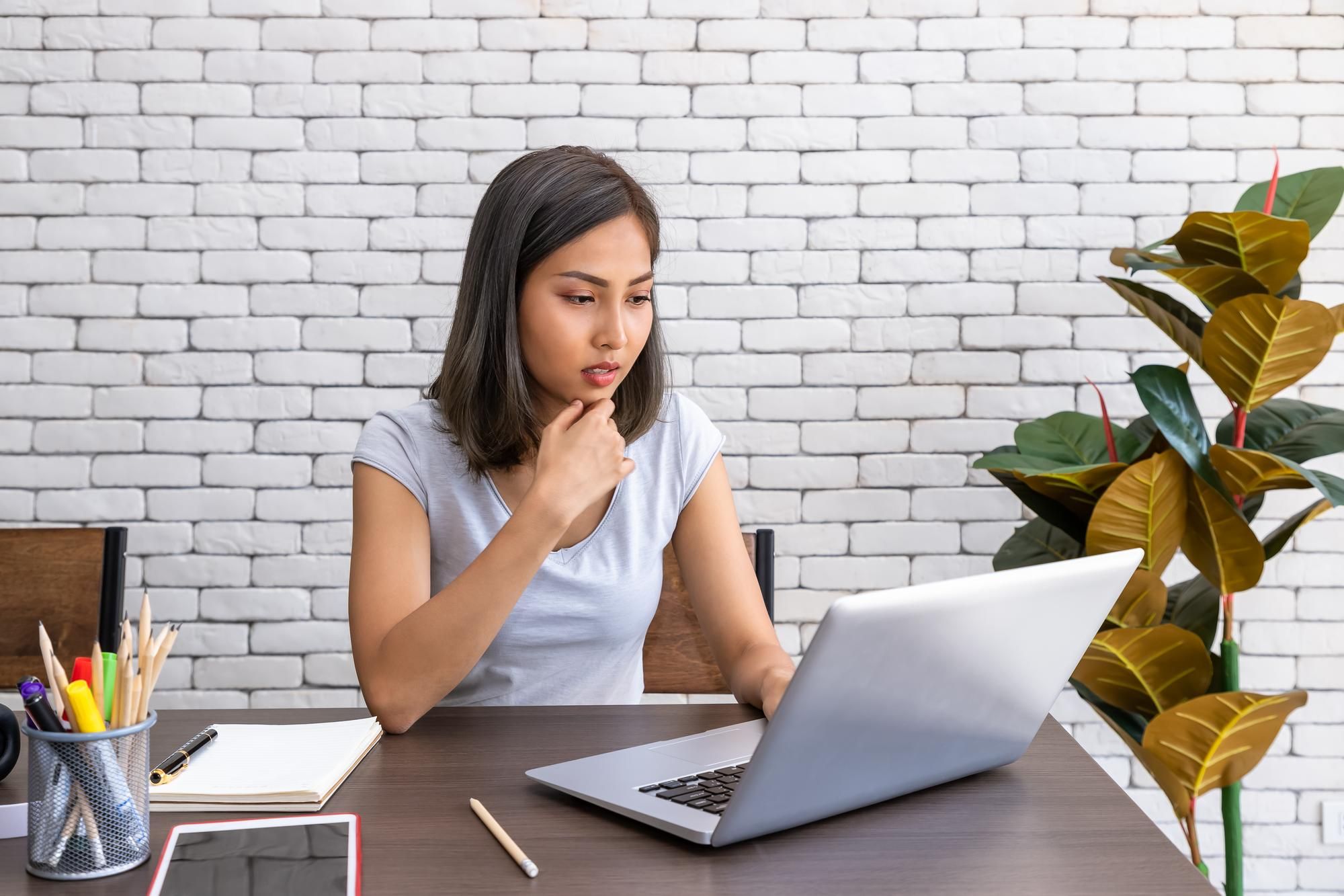 Una mujer trabaja sentada en un escritorio.