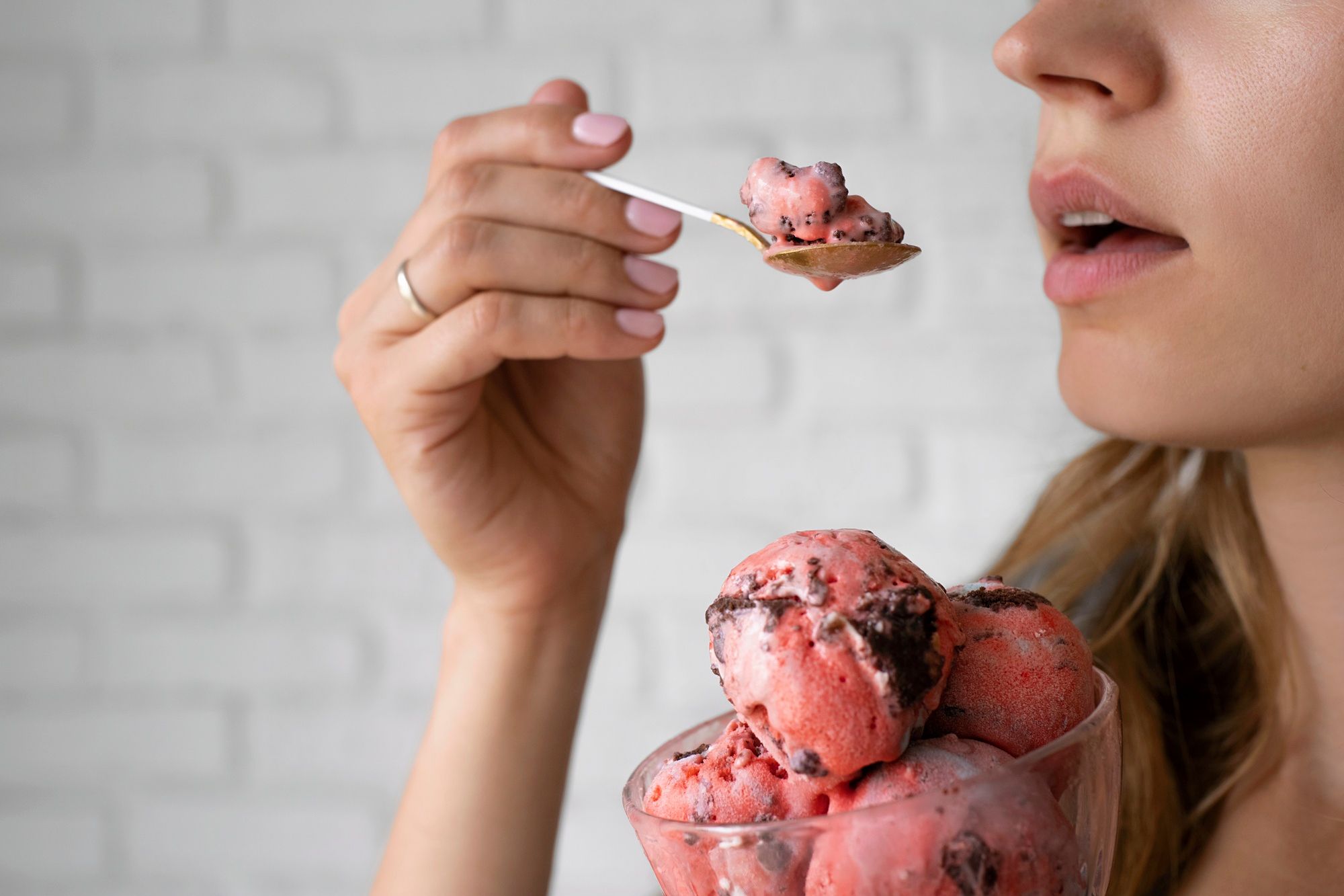Una mujer toma una copa de helado.