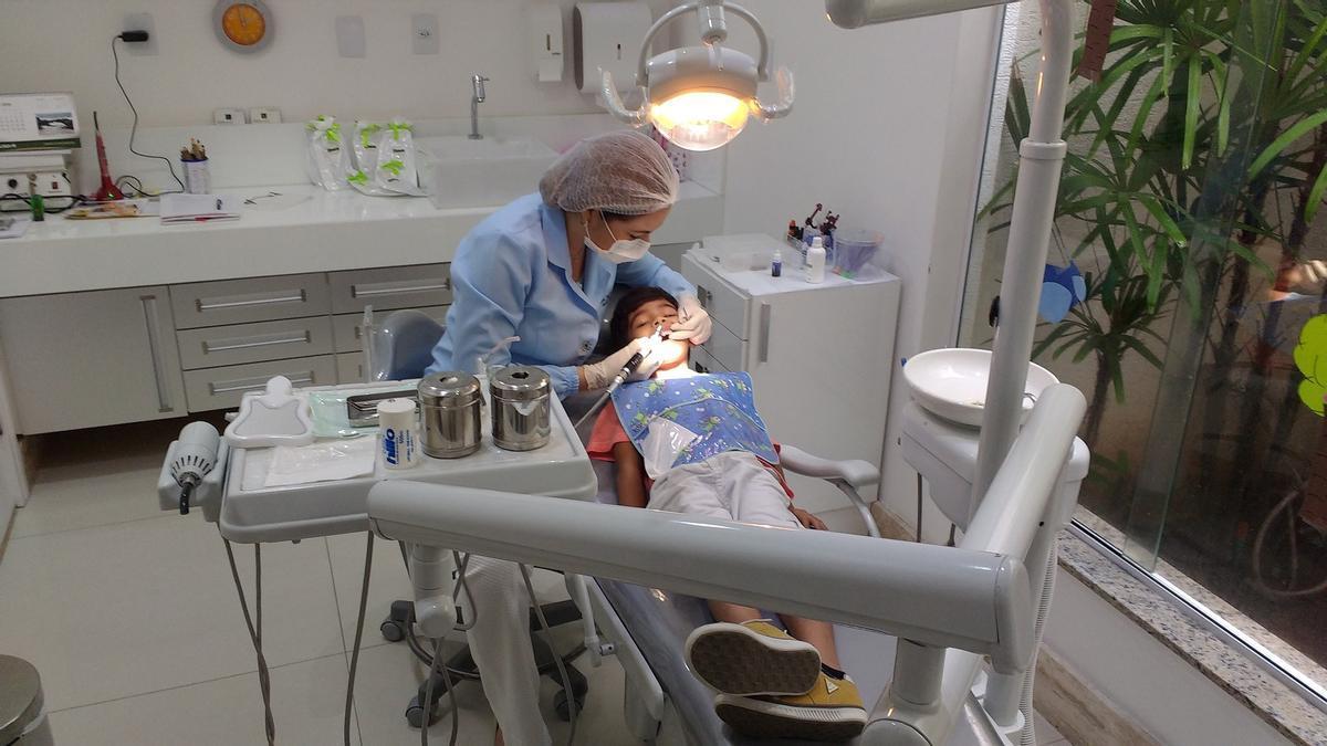 Una dentista atiende a un niño.