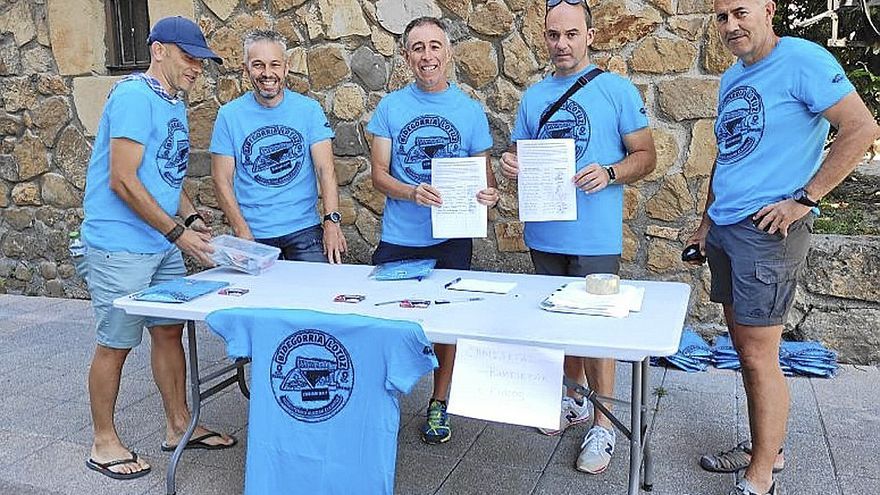 Voluntarios muestran documentos cerca del recinto.