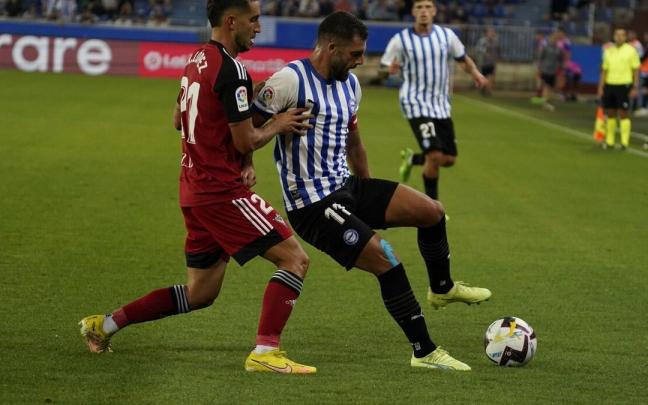 Luis Rioja protege un bal&oacute;n ante la presi&oacute;n de un futbolista del Mirand&eacute;s