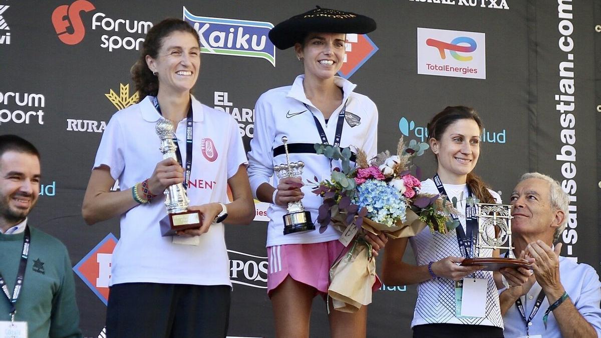 Mireia Guarner y Elena Silvestre escoltan en el podio a la vencedora de la Behobia, Cristina Silva