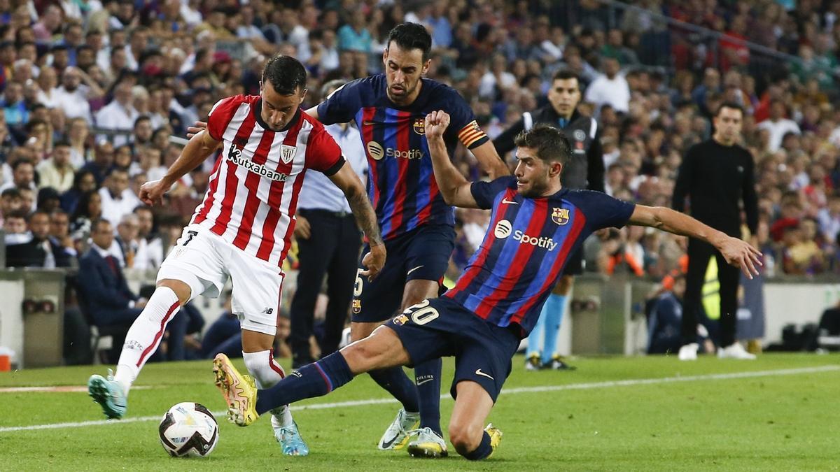 Alex Berenguer recibe la presión de Sergio Busquets y Sergi Roberto en el Campo Nou.