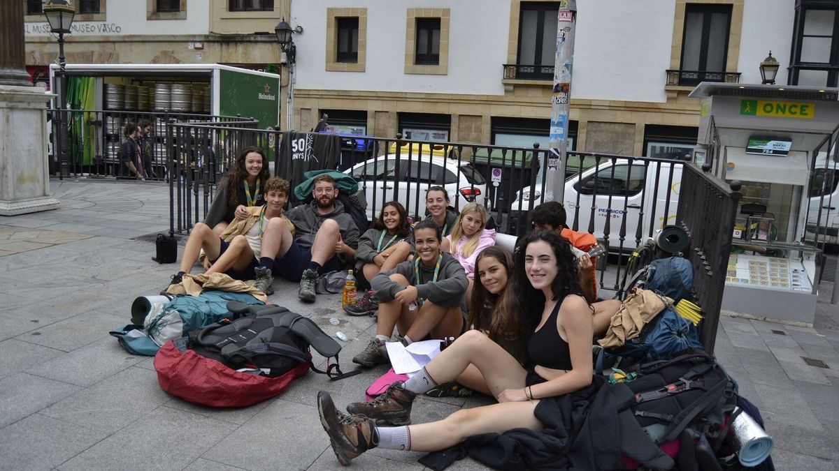 Las catalanas Maia y Laia hacen un alto en el camino acompañadas de su grupo scout en la plaza de Unamuno.