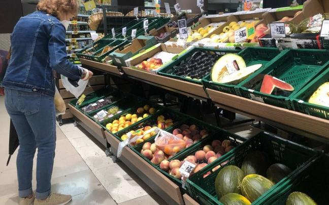 Una mujer realiza la compra en un supermercado de proximidad Una mujer realiza la compra en un supermercado de proximidad