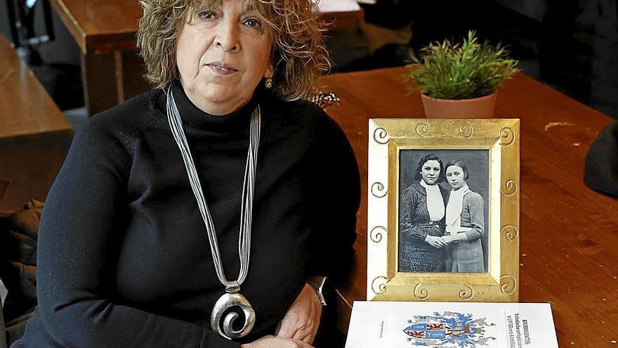 Rosa Ruiz, hija de Lucía Rodríguez Alonso, con un retrato de su madre, a la izquierda. | FOTOS: EFE