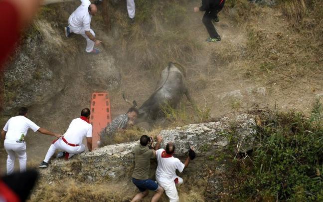 Un miembro de la DYA lanza una camilla para intentar evitar que la vaca cornee a Mari Lacruz