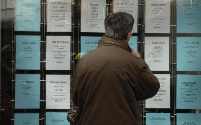 Un hombre mirando los precios en una inmobiliaria. Un hombre mirando los precios en una inmobiliaria.