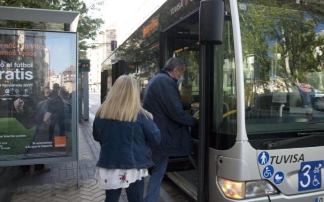 Un grupo de personas suben a un autobús urbano.