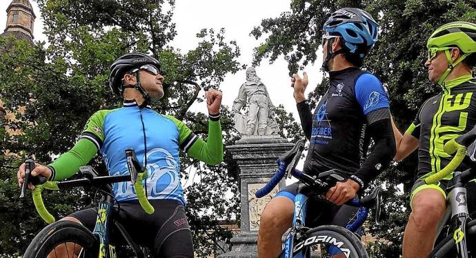 Tres ciclistas de Urretxu señalan la estatua de Iparragirre. Foto: Asier Leunda