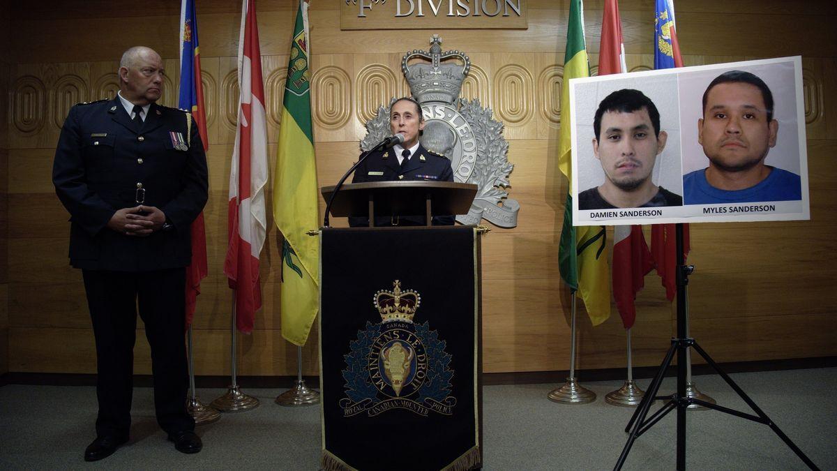 Policías canadienses junto a las imágenes de Damien y Myles Sanderson.
