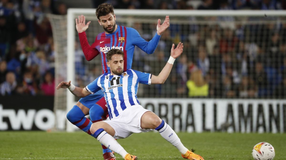 El centrocampista belga de la Real Sociedad, Adnan Januzaj, cae ante el defensa del FC Barcelona, Gerard Piqu&eacute;