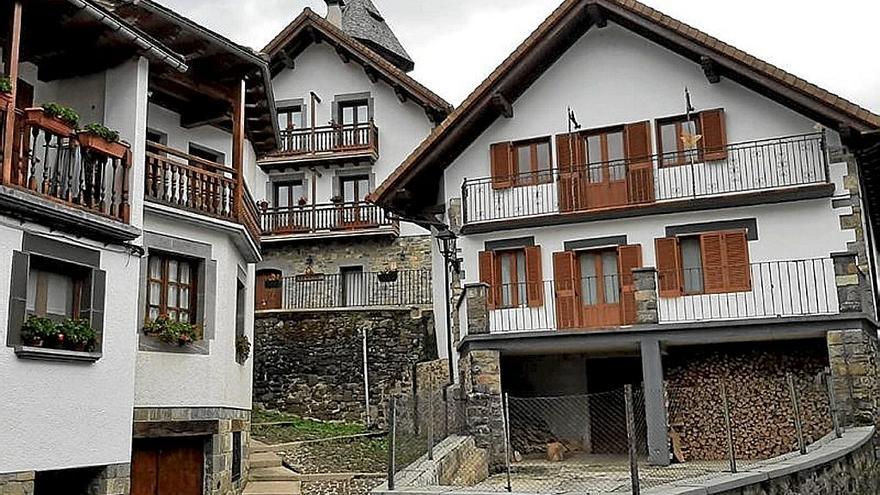 Las casas del valle guardan la leña para el invierno.