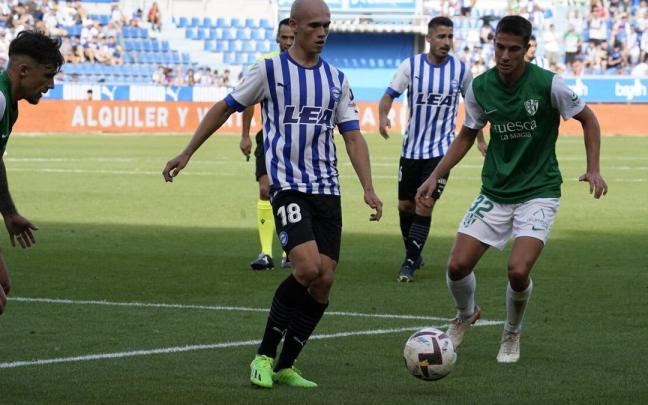 Guridi observa el esf&eacute;rico ante la presi&oacute;n de dos jugadores del Huesca
