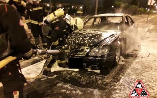 Los Bomberos apagando el fuego en el coche