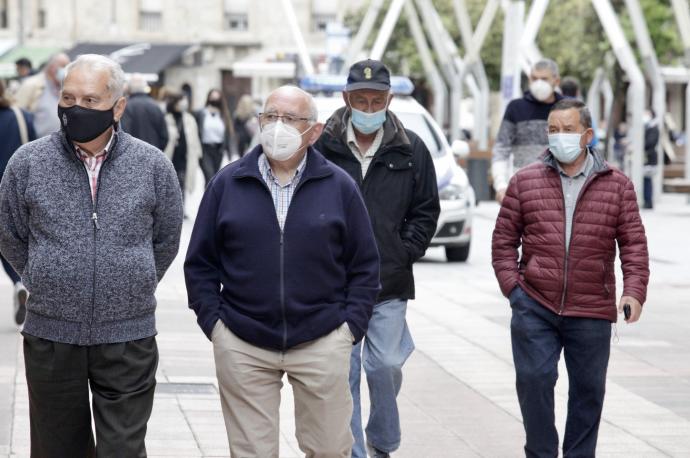 Personas andando por la calle con mascarilla para evitar contagios