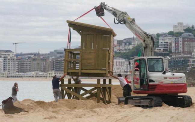 Una máquina ayuda a la colocación de la torreta de madera de los socorristas de Ondarreta.