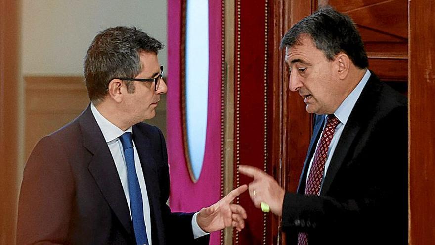 El ministro de la Presidencia, Félix Bolaños, conversa ayer con el portavoz jeltzale en Madrid, Aitor Esteban, en un receso del pleno en el Congreso.