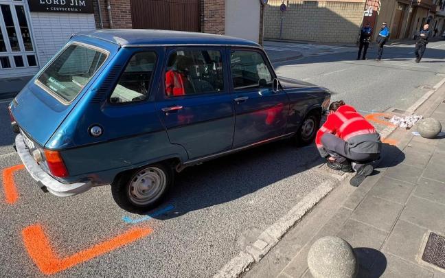 Un policía foral examina el turismo implicado en el atropello. Un policía foral examina el turismo implicado en el atropello.